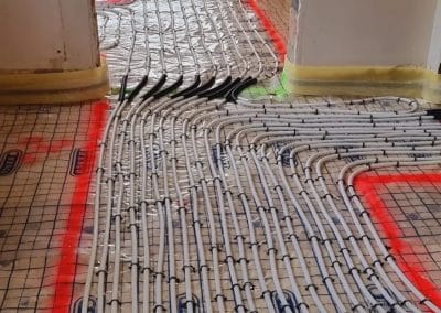 Plaatsing van vloerverwarming met buizen en isolatie in woning